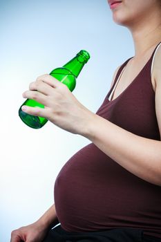 Pregnancy with alcohol. Pregnant female unhealthy motherhood concept. Side view of pregnant belly body part.