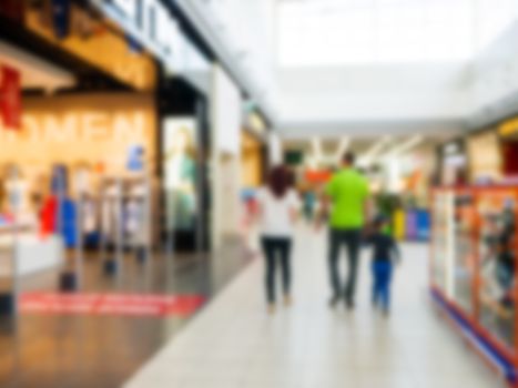 Abstract blurred shopping mall hall with unrecognizable persons as background