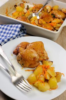 portion fried pieces  chicken with boiled potatoes and carrots on a plate