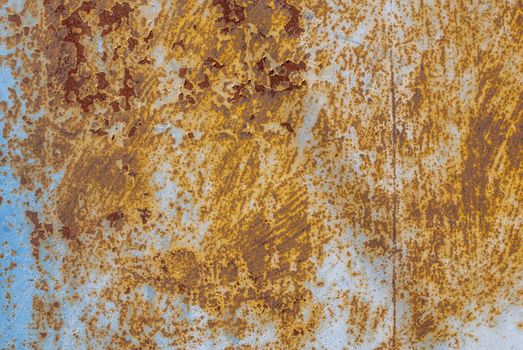 rusty iron surface covered with old chipped paint, which has long been influenced by different climatic conditions