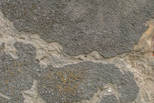 fragment of a concrete wall, which has undergone deformation due to prolonged exposure to various climatic conditions