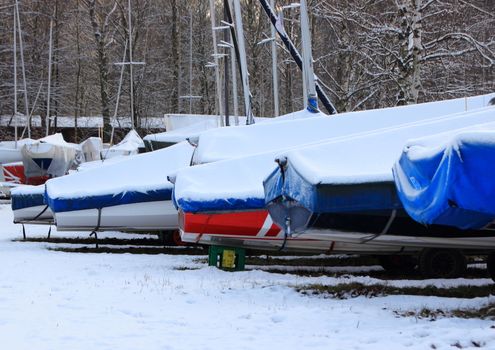 Perspective of sailing ships on shore with snow