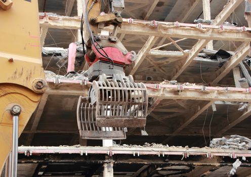 Heavy Crane Grab Tool at Demolition of Business Building