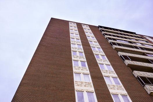Corner of a large brown building with many decks