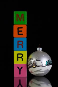 Colored children's cubes and Christmas decoration on a black glass desk