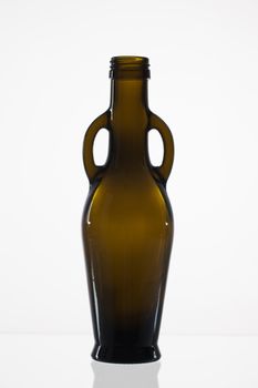 Empty bottle of olive oil on the glass desk