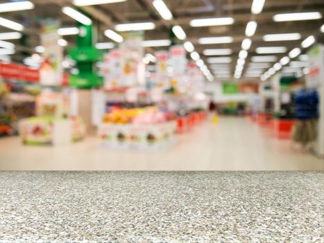 Marble board empty table in front of blurred background. Perspective marble over blur in supermarket - can be used for display or montage your products. Mock up for display of product.