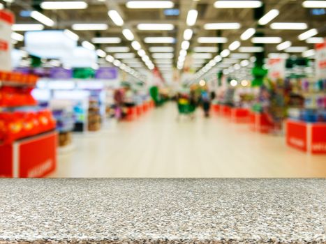 Marble board empty table in front of blurred background. Perspective marble over blur in supermarket - can be used for display or montage your products. Mock up for display of product.