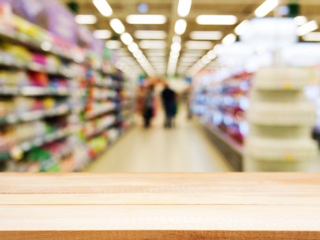 Wooden board empty table in front of blurred background. Perspective light wood over blur in supermarket - can be used for display or montage your products. Mock up for display of product.