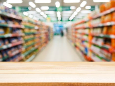 Wooden board empty table in front of blurred background. Perspective light wood over blur in supermarket - can be used for display or montage your products. Mock up for display of product.