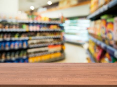 Wooden board empty table in front of blurred background. Perspective dark wood over blur in supermarket - can be used for display or montage your products. Mock up for display of product.