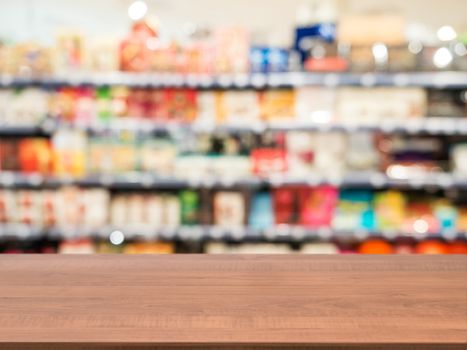 Wooden board empty table in front of blurred background. Perspective dark wood over blur in supermarket - can be used for display or montage your products. Mock up for display of product.