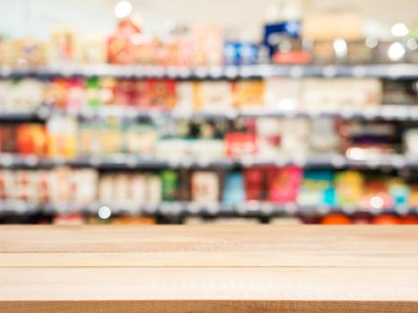 Wooden board empty table in front of blurred background. Perspective light wood over blur in supermarket - can be used for display or montage your products. Mock up for display of product.