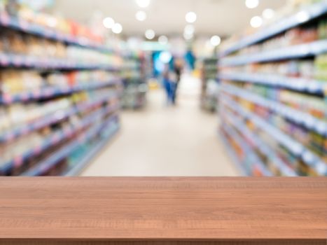 Wooden board empty table in front of blurred background. Perspective light wood over blur in supermarket - can be used for display or montage your products. Mock up for display of product.