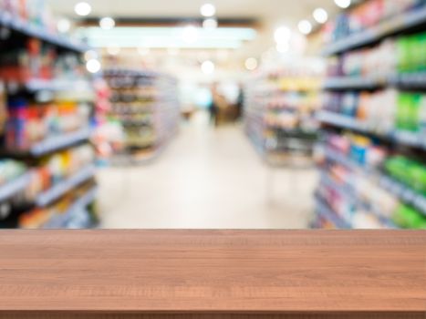 Wooden board empty table in front of blurred background. Perspective light wood over blur in supermarket - can be used for display or montage your products. Mock up for display of product.