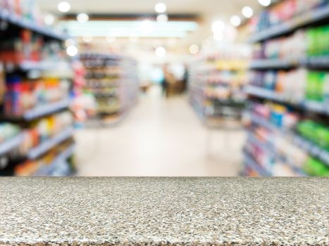 Marble board empty table in front of blurred background. Perspective marble over blur in supermarket - can be used for display or montage your products. Mock up for display of product.