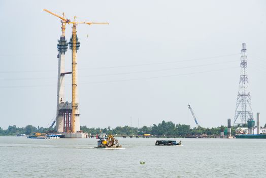 Cao Lanh, Vietnam - March 17, 2016: Car ferries in the Mekong Delta of Vietnam are rapidly being replaced by motorway bridges, like here near Cao Lanh, the capital of Dong Thap Province.