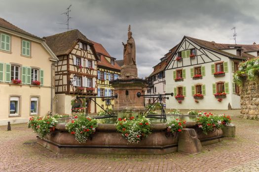 Saint-Leon fountain and traditional timbered houses in Eguisheim, Alsace, France