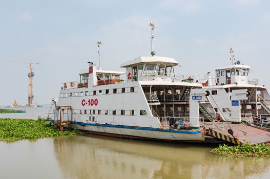 Cao Lanh, Vietnam - March 17, 2016: Car ferries in the Mekong Delta of Vietnam are rapidly being replaced by motorway bridges, like here near Cao Lanh, the capital of Dong Thap Province.