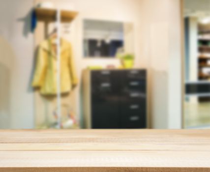 Wooden empty table in front of blurred background. Perspective light wood over blur in modern apartment interior. Mock up for display or montage your products