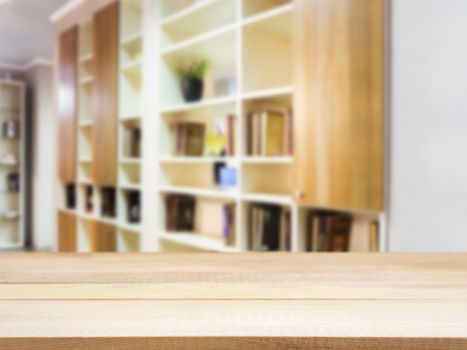 Wooden board empty table in front of blurred background. Perspective light wood over blur in modern living room interior. Mock up for display or montage your products