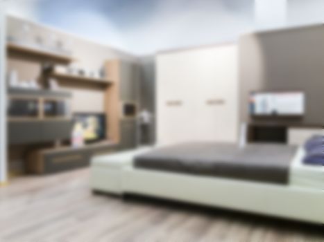 Abstract blur interior of modern comfortable hotel bedroom. Blurred bedroom with white bed