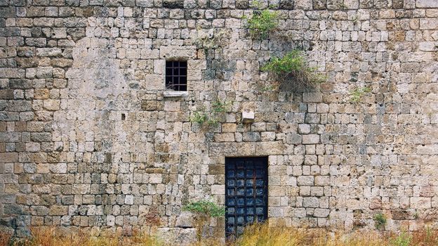 antique wall with the window and the door