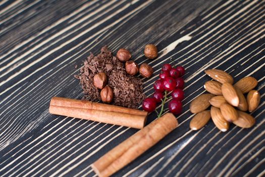 Nuts, cinnamon, candied fruits, chocolate chips lie on the texture table