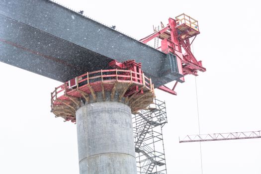 Bridge construction sites, bridge under construction seen in heavy snowfall from below.