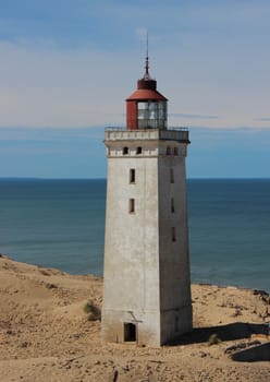 Old Lighthouse at Edge with Ocean in Background