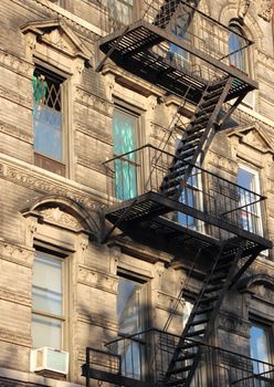 New York Black Metal Fire Escape Ladder with Green Windows in Perspective
