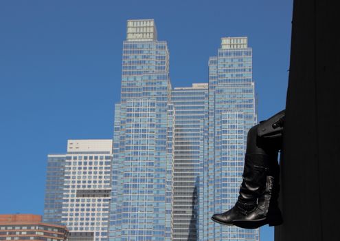 Resting Black Leather Boots with Skyscraper Background Abstract