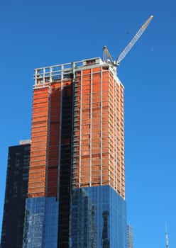 Skyscraper Building Site Half Completed with Crane on Top