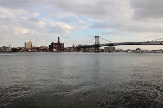 Metal Bridge Crossing East River with Dark Water Perspective