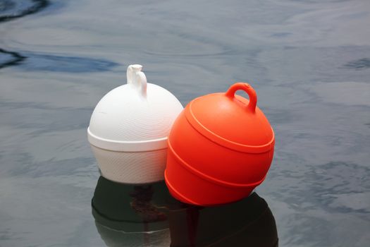 Orange And White Buoys in the Sea
