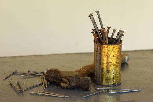 Vintage hammer with nails on metallic background with copy space. Carpenter's outfit
