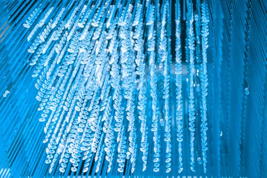 Modern glass chandelier. Decorative blue crystal chandelier on the ceiling - interior decoration abstract background. Abstract background texture