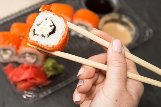 Sushi roll philadelphia. Philadelphia roll in Disposable Plastic Food Container. Business lunch concept