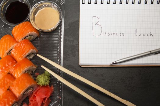 Sushi roll philadelphia. Philadelphia roll in Disposable Plastic Food Container. Business lunch concept