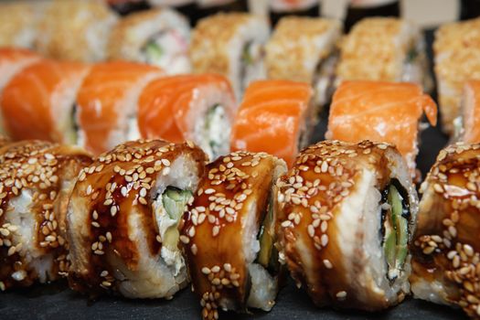 Best Types of Sushi Rolls. Philadelphia Roll, California Roll, Eel Avocado Roll. Delicious rolls and sushi with eel, salmon, shrimp, cucumber and philadelphia. Various delicious Types of Sushi Rolls