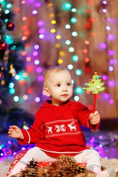 Little baby girl waiting for a miracle in Christmas decorations