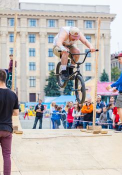 KHARKOV, UKRAINE - JUNE 11, 2016: Young guy is showing extreme jumps on a skate stage