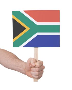 Hand holding small card, isolated on white - Flag of South Africa