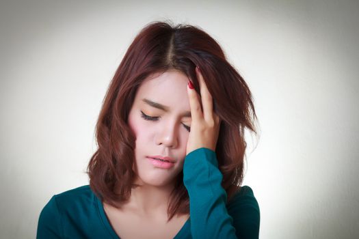 Headache. Young asian woman having a headache