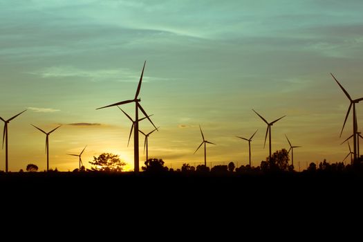 Wind turbine power generator at twilight sunset