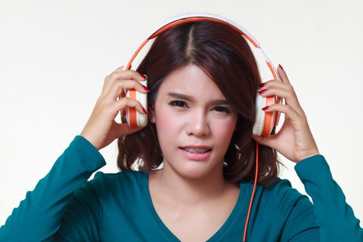 portrait of beautiful young woman with earphones listening a bad music noise