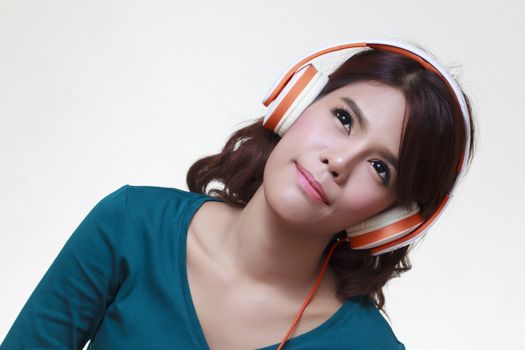 Beautiful young woman with headphones listening to the music