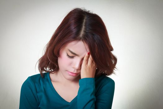 Headache. Young asian woman having a headache