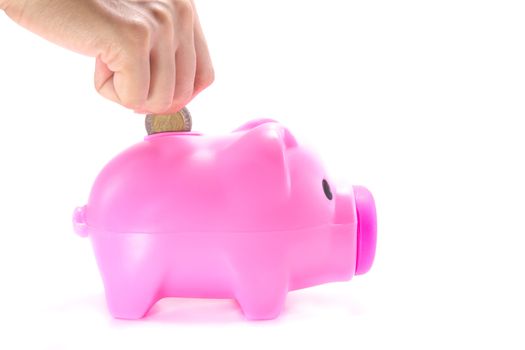 Hand of woman Putting Coin In Piggy Bank isolate on white background