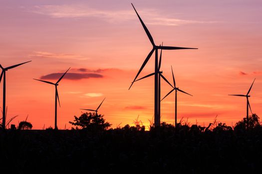 Wind turbine power generator at twilight sunset